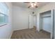 This carpeted bedroom offers a ceiling fan and a standard sized closet at 4121 Caywood Cir, Orlando, FL 32810
