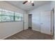 This is a carpeted bedroom with a window, door, and closet for optimal functionality at 4121 Caywood Cir, Orlando, FL 32810