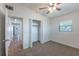 This carpeted bedroom contains a standard sized closet, and a view of the hallway at 4121 Caywood Cir, Orlando, FL 32810