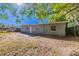 Back of the home featuring windows, back door, concrete patio and outdoor space at 4121 Caywood Cir, Orlando, FL 32810