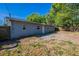 Exterior side view of the house, showcasing windows and a small concrete patio at 4121 Caywood Cir, Orlando, FL 32810