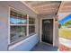 Close up of home's entry door with large windows bringing in lots of natural light at 4121 Caywood Cir, Orlando, FL 32810