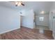 Open floorplan featuring wood-look flooring, neutral walls and updated light fixtures at 4121 Caywood Cir, Orlando, FL 32810