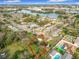 Aerial view of a property surrounded by trees, with a lake and city skyline in the distance at 444 Sunnyview Cir, Orlando, FL 32810
