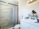 Bright bathroom with a modern vanity, stylish shower tiles, and patterned curtain at 444 Sunnyview Cir, Orlando, FL 32810