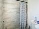 Bright bathroom with a modern shower, stylish shower tiles, and patterned curtain at 444 Sunnyview Cir, Orlando, FL 32810