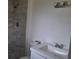 Contemporary bathroom featuring tiled shower, modern vanity, and fixtures at 444 Sunnyview Cir, Orlando, FL 32810