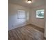 Comfortable bedroom showcasing updated flooring and a sunny window at 444 Sunnyview Cir, Orlando, FL 32810