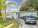 Charming single-story home featuring secure windows and door, landscaping, and private driveway at 444 Sunnyview Cir, Orlando, FL 32810