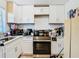 Functional kitchen featuring white cabinetry, modern appliances, and ample counter space at 444 Sunnyview Cir, Orlando, FL 32810