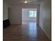 Open living room with wood-look flooring and large window allowing for lots of natural light at 444 Sunnyview Cir, Orlando, FL 32810