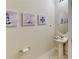 Half bathroom with a nautical theme, pedestal sink, and tiled floors at 4512 Sparkling Shell Ave, Kissimmee, FL 34746