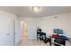 Bedroom with light carpet, a desk and view into the bathroom at 4512 Sparkling Shell Ave, Kissimmee, FL 34746