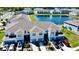 Beautiful townhomes featuring garages, driveways, and a scenic pond in a well-maintained community at 4512 Sparkling Shell Ave, Kissimmee, FL 34746