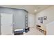 Foyer area with grey accent wall with decorative accents, seating and storage at 4512 Sparkling Shell Ave, Kissimmee, FL 34746