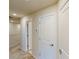 Hallway with carpet and access to several rooms via white doors with brushed metal hardware at 4512 Sparkling Shell Ave, Kissimmee, FL 34746