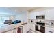 Open kitchen featuring stainless steel appliances, granite countertops, and white cabinetry at 4512 Sparkling Shell Ave, Kissimmee, FL 34746
