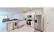Modern kitchen with stainless steel appliances, granite countertops, and white cabinetry at 4512 Sparkling Shell Ave, Kissimmee, FL 34746