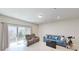 Living room with plush seating, recessed lighting, and sliding glass doors at 4512 Sparkling Shell Ave, Kissimmee, FL 34746