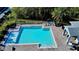 Enjoy the community pool with ample seating and beautiful landscaping, perfect for relaxation and leisure at 4512 Sparkling Shell Ave, Kissimmee, FL 34746