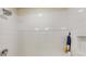 Modern shower showcasing sleek white tiling, contemporary fixtures, and convenient built-in niche at 4512 Sparkling Shell Ave, Kissimmee, FL 34746