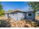 Backyard view of a light grey home featuring a small window at 5206 Cortez Dr, Orlando, FL 32808
