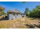 View of the gray home's backyard and exterior showing windows and outdoor features at 5206 Cortez Dr, Orlando, FL 32808