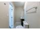 Compact half bathroom featuring a dark wood vanity, mirror, and coordinating fixtures at 5206 Cortez Dr, Orlando, FL 32808