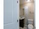 Half bathroom features a compact vanity, mirror, and toilet in a neatly organized space at 5206 Cortez Dr, Orlando, FL 32808