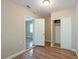 Bedroom featuring wood floors, an open closet, and easy access to other living spaces at 5206 Cortez Dr, Orlando, FL 32808