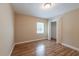 Bedroom with hard wood flooring, a closet, neutral paint and a window at 5206 Cortez Dr, Orlando, FL 32808