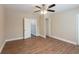 Bedroom with wood-look flooring, a ceiling fan, closet, and neutral walls at 5206 Cortez Dr, Orlando, FL 32808