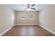 Spacious bedroom with wood-look flooring, ceiling fan, and two windows offering natural light at 5206 Cortez Dr, Orlando, FL 32808