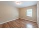 Bright bedroom featuring wood flooring, a window and neutral paint at 5206 Cortez Dr, Orlando, FL 32808