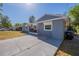 Inviting single-story home showcasing a clean exterior, white-trimmed windows, and a spacious concrete driveway under the sun at 5206 Cortez Dr, Orlando, FL 32808