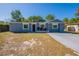 Beautiful one-story home featuring a well-maintained yard, simple landscaping, and a freshly painted gray facade at 5206 Cortez Dr, Orlando, FL 32808
