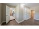 Hallway view with neutral paint, wood floors, and doorway views to the kitchen and other rooms at 5206 Cortez Dr, Orlando, FL 32808