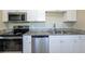 Well-appointed kitchen featuring granite countertops, stainless steel appliances, and sleek white cabinetry at 5206 Cortez Dr, Orlando, FL 32808