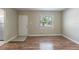 Inviting living room with wood flooring, a bright window, and a welcoming front door at 5206 Cortez Dr, Orlando, FL 32808