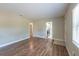 Open-concept living space with wood floors, a view into the kitchen, and ample natural light at 5206 Cortez Dr, Orlando, FL 32808