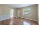 Comfortable living area with wood-style floors, a window view, and easy access to the kitchen at 5206 Cortez Dr, Orlando, FL 32808