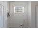 Small utility room featuring tile floor, a window and utilities at 5206 Cortez Dr, Orlando, FL 32808