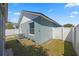 Private fenced-in backyard offering ample space, and a house with light teal siding at 536 Southern Charm Dr, Orlando, FL 32807