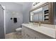 Well lit bathroom with a large mirror above a white vanity and a shower behind a curtain at 536 Southern Charm Dr, Orlando, FL 32807