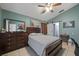This comfortable bedroom features tile flooring, a ceiling fan, and ensuite bathroom access at 536 Southern Charm Dr, Orlando, FL 32807