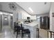 The modern kitchen features white cabinets, tile backsplash, stainless steel appliances, and a breakfast bar with seating at 536 Southern Charm Dr, Orlando, FL 32807