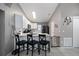 The modern kitchen features white cabinets, tile backsplash, stainless steel appliances, and a breakfast bar with seating at 536 Southern Charm Dr, Orlando, FL 32807