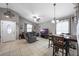 The open living room features tile floors, a ceiling fan, and neutral paint, seamlessly connecting living and dining areas at 536 Southern Charm Dr, Orlando, FL 32807