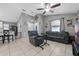 The open living room features tile floors, a ceiling fan, and neutral paint, creating a cozy and inviting space at 536 Southern Charm Dr, Orlando, FL 32807