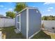 This backyard features a storage shed with a white door and trim on a grass lawn at 536 Southern Charm Dr, Orlando, FL 32807